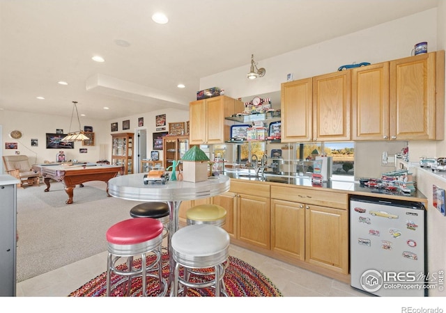 7421 18th St, Greeley, CO 80634 - kitchen with light brown cabinetry, a sink, recessed lighting, billiards, and refrigerator