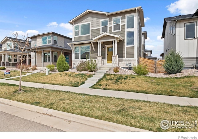 2838 Sykes Dr, Fort Collins, CO 80524 - view of front of home with brick siding, a front yard, and fence