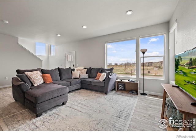 2838 Sykes Dr, Fort Collins, CO 80524 - living area with plenty of natural light, baseboards, and wood finished floors