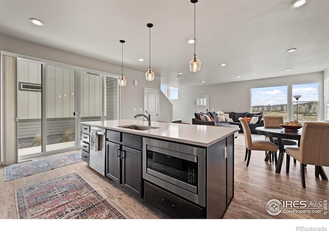 2838 Sykes Dr, Fort Collins, CO 80524 - kitchen featuring light wood-style flooring, a sink, recessed lighting, decorative light fixtures, and appliances with stainless steel finishes