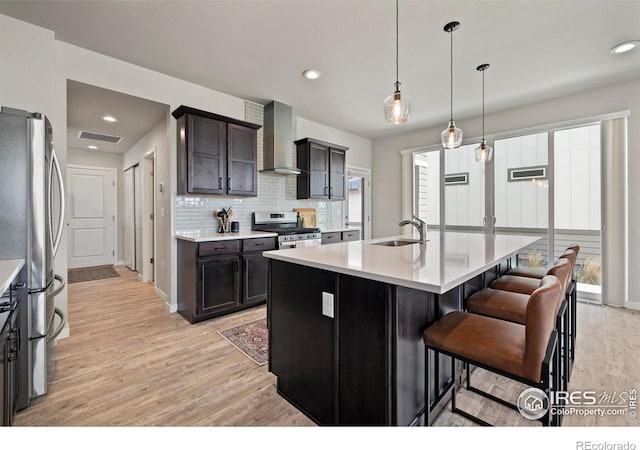2838 Sykes Dr, Fort Collins, CO 80524 - kitchen featuring a sink, light wood-type flooring, stainless steel appliances, light countertops, and wall chimney exhaust hood