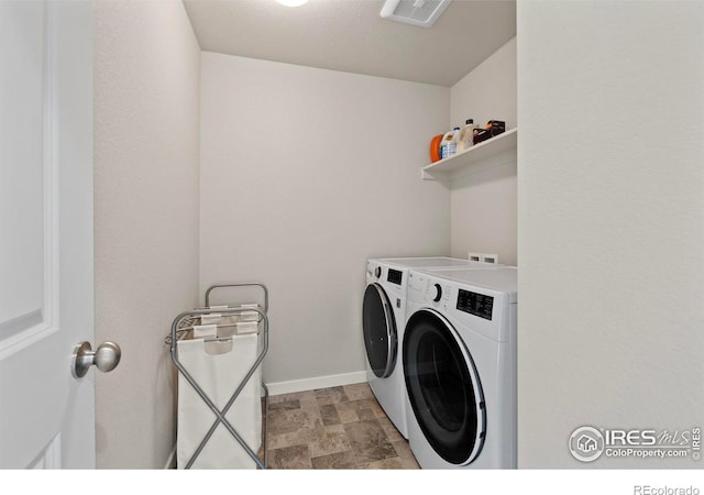 2838 Sykes Dr, Fort Collins, CO 80524 - laundry room with separate washer and dryer, laundry area, baseboards, stone finish floor, and visible vents