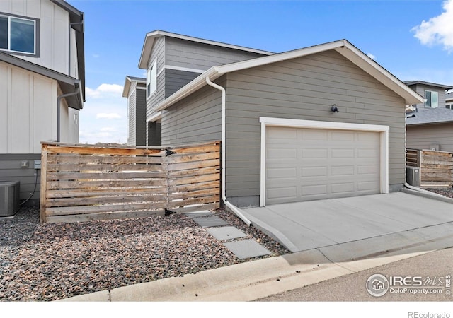 2838 Sykes Dr, Fort Collins, CO 80524 - exterior space with fence, board and batten siding, central AC, and concrete driveway