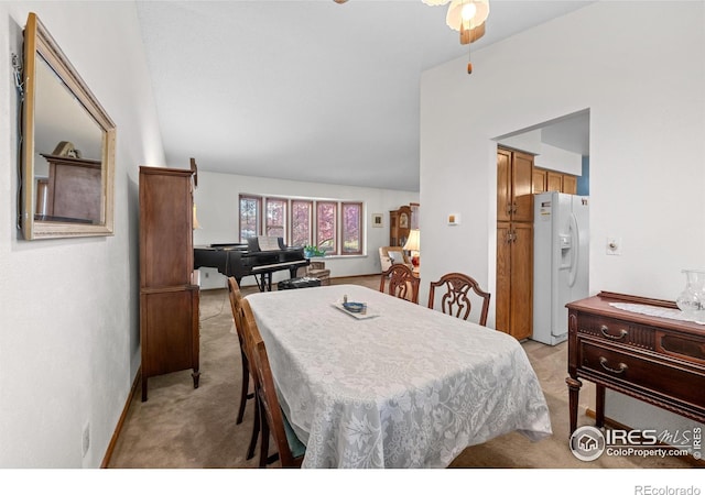 2417 15th Ave, Longmont, CO 80503 - dining room with ceiling fan, vaulted ceiling, and light colored carpet