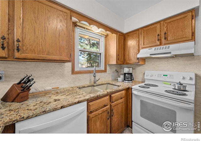 2417 15th Ave, Longmont, CO 80503 - kitchen featuring under cabinet range hood, tasteful backsplash, a sink, and white appliances
