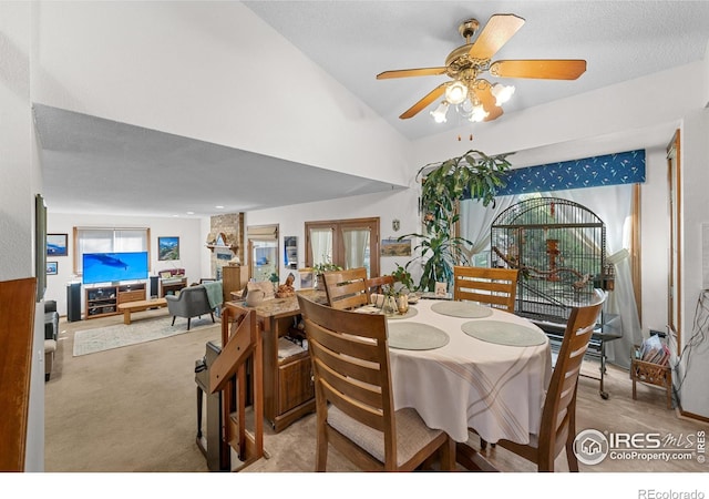 2417 15th Ave, Longmont, CO 80503 - carpeted dining space featuring vaulted ceiling and a ceiling fan