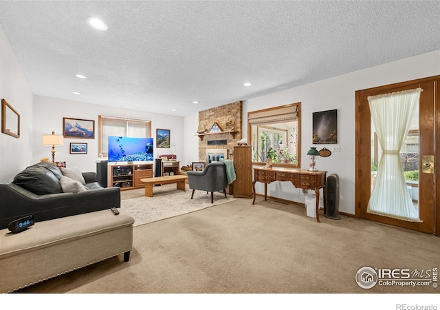 2417 15th Ave, Longmont, CO 80503 - living room featuring a fireplace, carpet floors, a textured ceiling, and recessed lighting