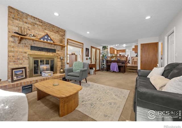 2417 15th Ave, Longmont, CO 80503 - carpeted living room featuring recessed lighting, visible vents, a fireplace, and a textured ceiling