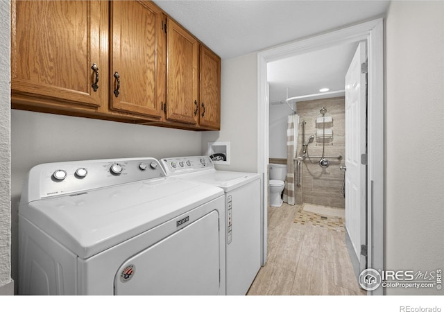 2417 15th Ave, Longmont, CO 80503 - laundry room featuring cabinet space, light wood-type flooring, and separate washer and dryer