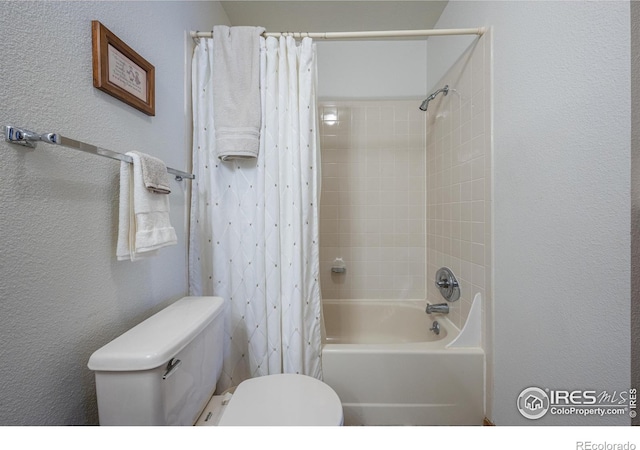2417 15th Ave, Longmont, CO 80503 - bathroom featuring shower / bath combo, toilet, and a textured wall