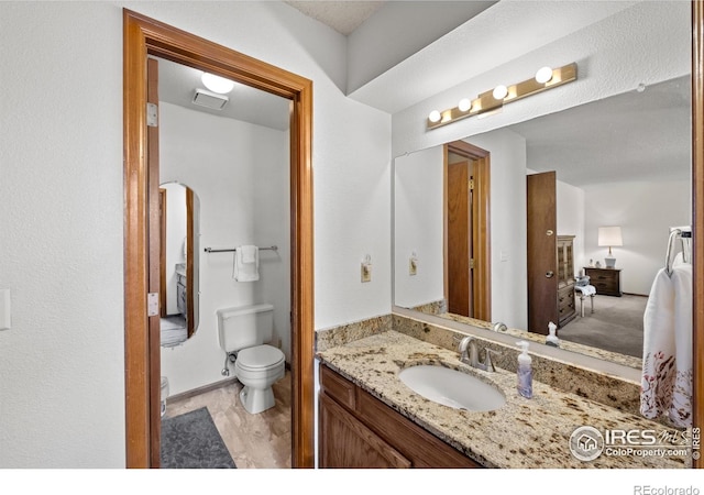 2417 15th Ave, Longmont, CO 80503 - bathroom with visible vents, toilet, and vanity