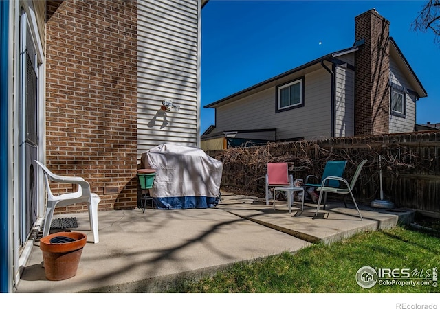 2417 15th Ave, Longmont, CO 80503 - view of patio with a fenced backyard and a grill