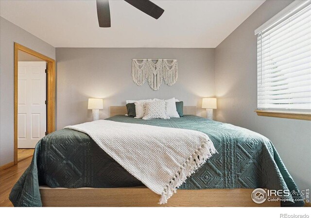 1114 Berwick Ct, Fort Collins, CO 80524 - bedroom with wood finished floors and ceiling fan