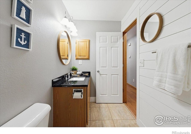 1114 Berwick Ct, Fort Collins, CO 80524 - half bathroom featuring vanity, tile patterned flooring, and toilet