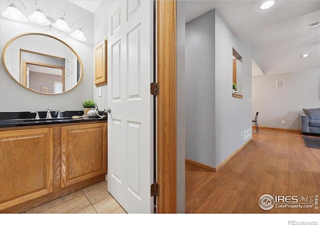 1114 Berwick Ct, Fort Collins, CO 80524 - bathroom featuring vanity, wood finished floors, recessed lighting, and baseboards