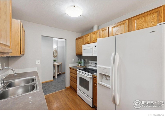 1114 Berwick Ct, Fort Collins, CO 80524 - kitchen with white appliances, a sink, and light wood finished floors