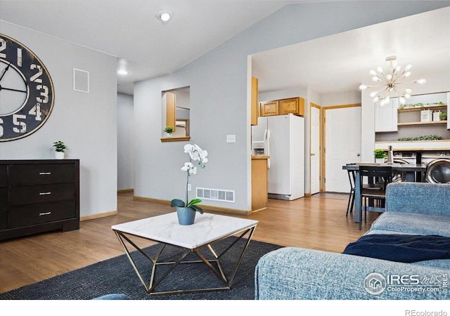 1114 Berwick Ct, Fort Collins, CO 80524 - living room featuring wood finished floors, a chandelier, baseboards, and recessed lighting