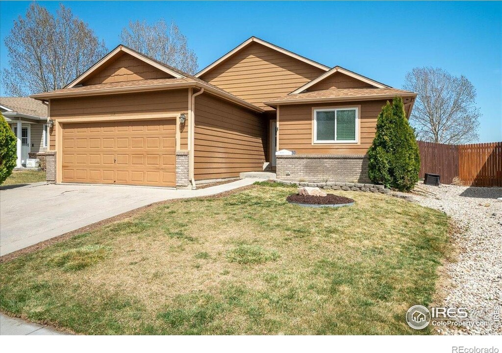 1114 Berwick Ct, Fort Collins, CO 80524 - single story home featuring a garage, brick siding, and concrete driveway
