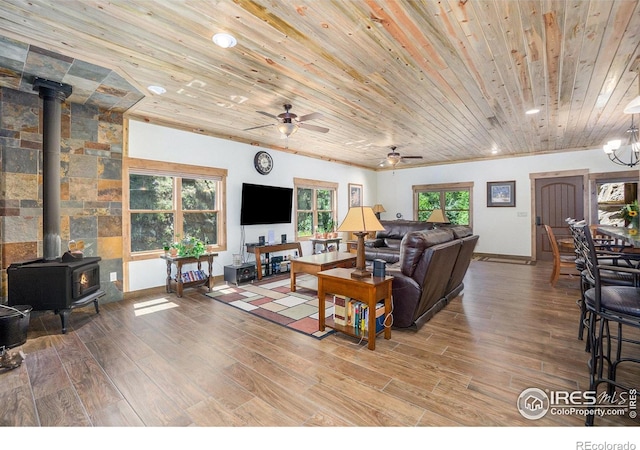 223 Kings Canyon Rd, Bellvue, CO 80512 - living area with a wood stove, wood ceiling, wood finished floors, a ceiling fan, and baseboards