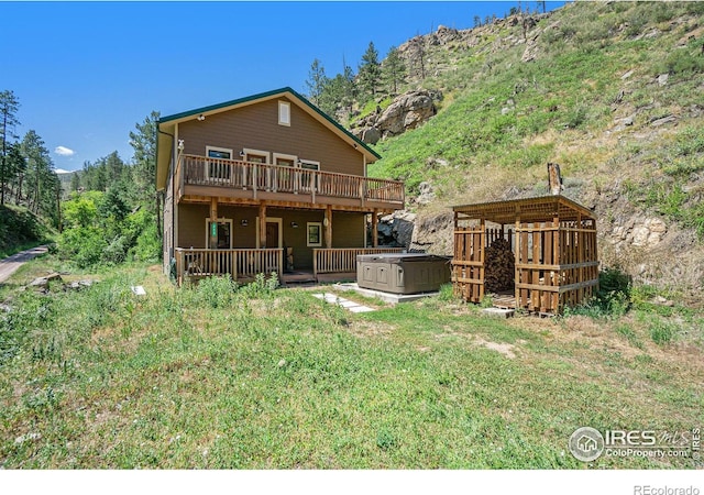 223 Kings Canyon Rd, Bellvue, CO 80512 - rear view of property with a hot tub and a deck