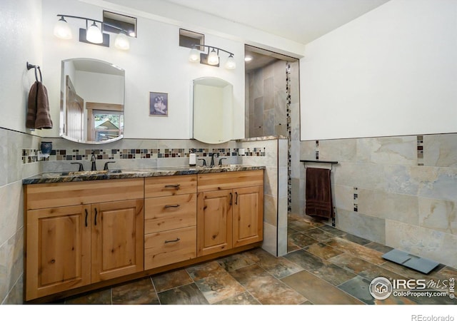 223 Kings Canyon Rd, Bellvue, CO 80512 - full bath featuring tile walls, double vanity, and stone finish floors