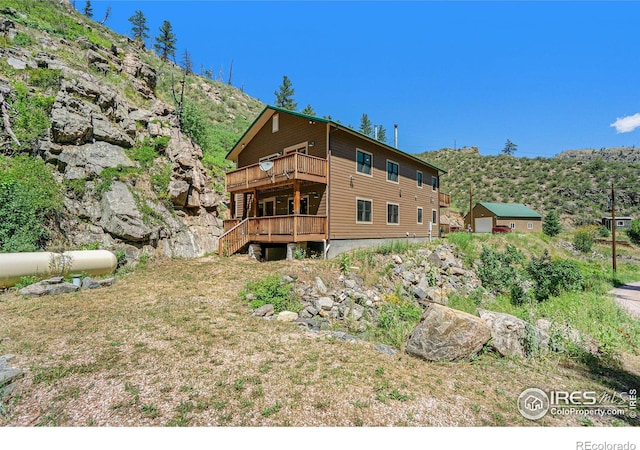223 Kings Canyon Rd, Bellvue, CO 80512 - rear view of house featuring a deck
