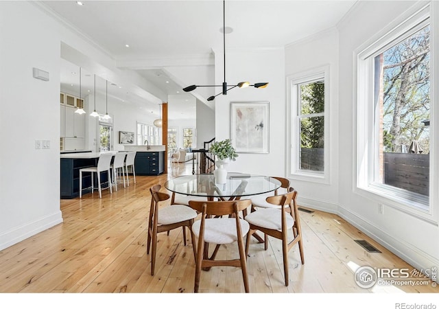 563 Arapahoe Ave, Boulder, CO 80302 - dining space featuring light wood-style floors, crown molding, baseboards, and recessed lighting
