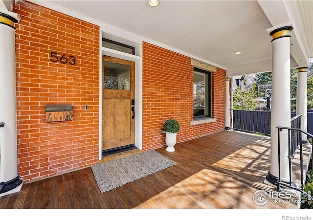 563 Arapahoe Ave, Boulder, CO 80302 - doorway to property featuring covered porch, brick siding, and water heater