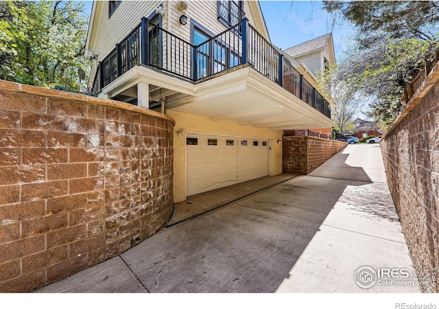 563 Arapahoe Ave, Boulder, CO 80302 - view of property exterior featuring a balcony, a garage, and concrete driveway