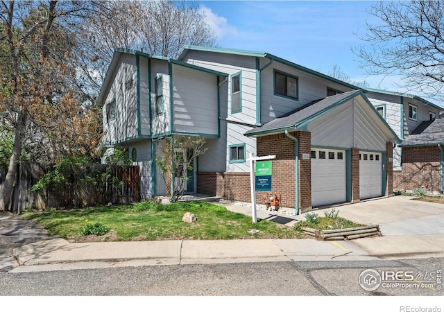 view of front facade featuring an attached garage, fence, brick siding, and concrete driveway