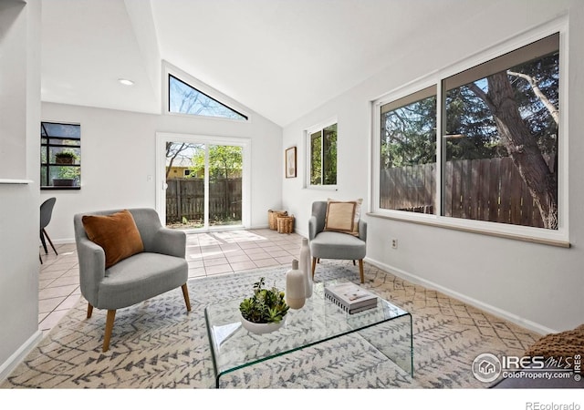tiled living room with vaulted ceiling and baseboards