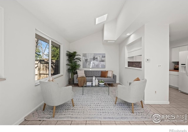 tiled living area featuring lofted ceiling and baseboards