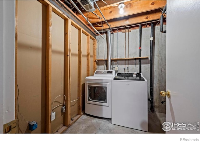 washroom featuring washing machine and clothes dryer and laundry area