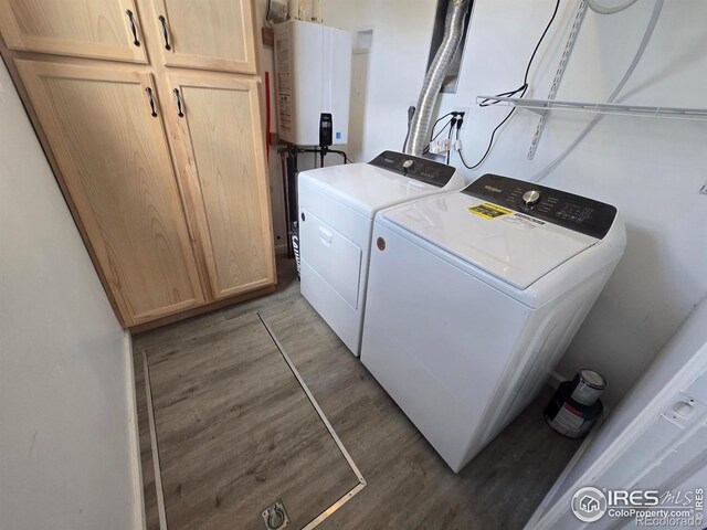 409 N 4th Ave, Sterling, CO 80751 - laundry area featuring cabinet space, washer and dryer, tankless water heater, and wood finished floors