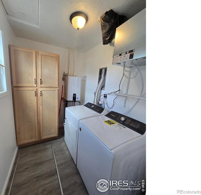 409 N 4th Ave, Sterling, CO 80751 - laundry area with water heater, independent washer and dryer, cabinet space, dark wood-style flooring, and baseboards