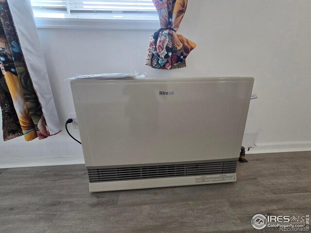 409 N 4th Ave, Sterling, CO 80751 - detailed view of heating unit, wood finished floors, and baseboards