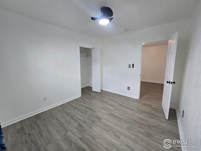 409 N 4th Ave, Sterling, CO 80751 - unfurnished bedroom featuring wood finished floors, baseboards, and a closet