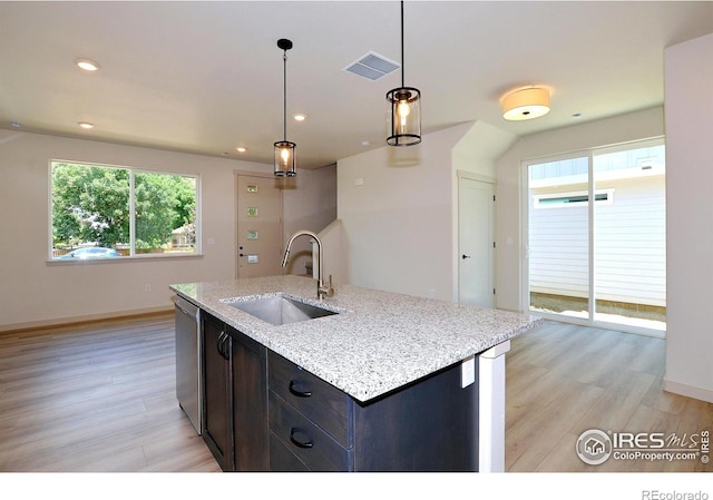 1039 Spartan Ave, Berthoud, CO 80513 - kitchen with light wood-type flooring, a wealth of natural light, visible vents, and a sink