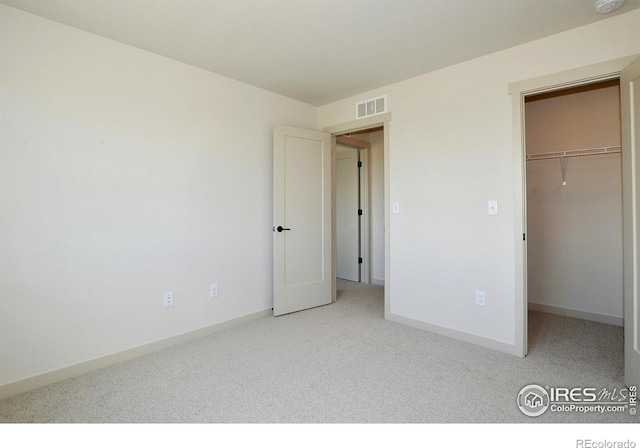 1039 Spartan Ave, Berthoud, CO 80513 - unfurnished bedroom with a spacious closet, visible vents, a closet, baseboards, and carpet flooring