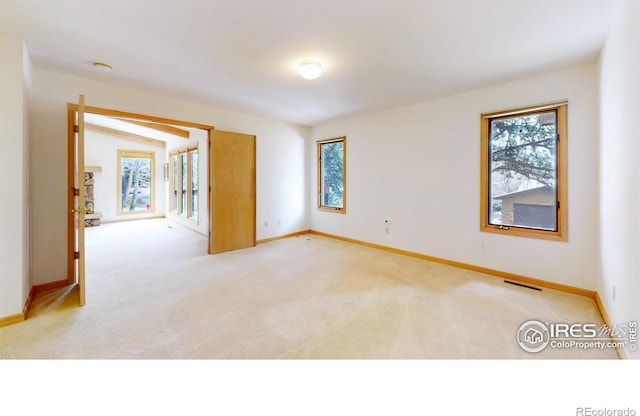 1162 Fairway Club Ln Unit 1, Estes Park, CO 80517 - unfurnished room featuring light carpet, baseboards, and a wealth of natural light