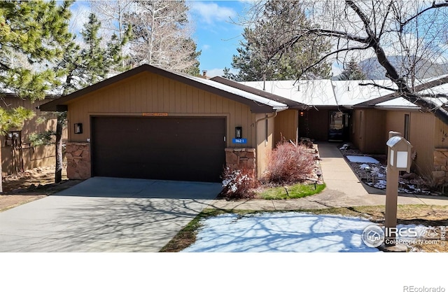 1162 Fairway Club Ln Unit 1, Estes Park, CO 80517 - single story home with a garage, driveway, stone siding, and fence