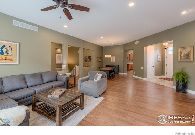 living room with light wood finished floors, visible vents, recessed lighting, and ceiling fan