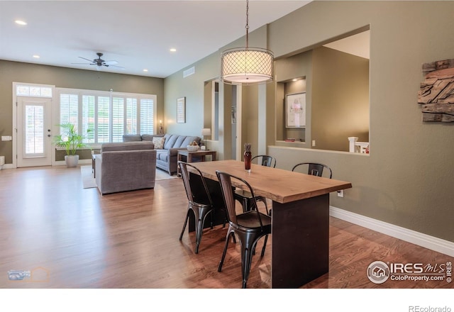 dining space featuring recessed lighting, wood finished floors, visible vents, a ceiling fan, and baseboards