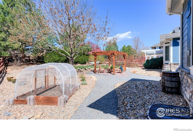 view of yard featuring a pergola, a garden, and central air condition unit
