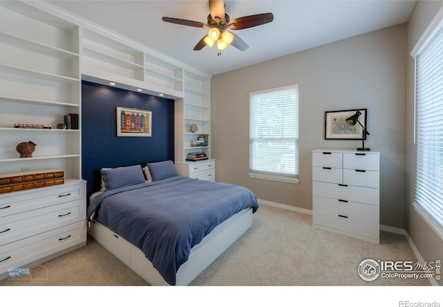 bedroom featuring baseboards, light colored carpet, and multiple windows