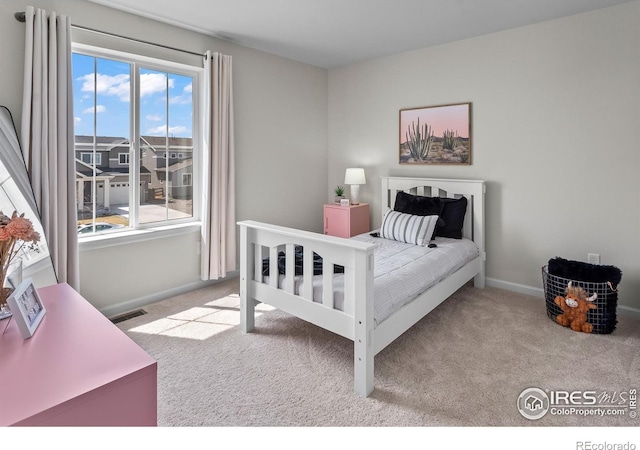 bedroom featuring baseboards, visible vents, and carpet