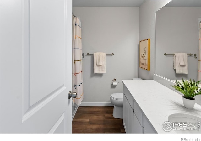 bathroom with toilet, baseboards, wood finished floors, a shower with shower curtain, and vanity