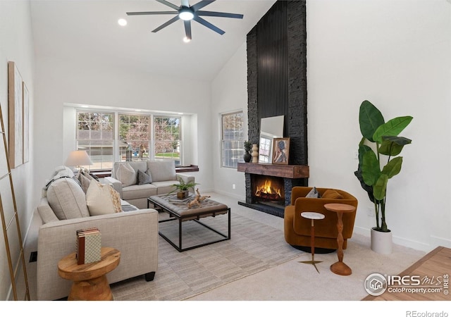 7102 S Harrison Ct, Centennial, CO 80122 - living area with high vaulted ceiling, a ceiling fan, a fireplace, light carpet, and baseboards