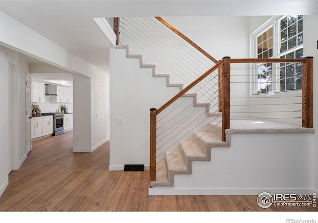7102 S Harrison Ct, Centennial, CO 80122 - staircase featuring wood finished floors and baseboards