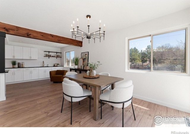 7102 S Harrison Ct, Centennial, CO 80122 - dining area featuring a chandelier, light wood-style floors, baseboards, and beam ceiling